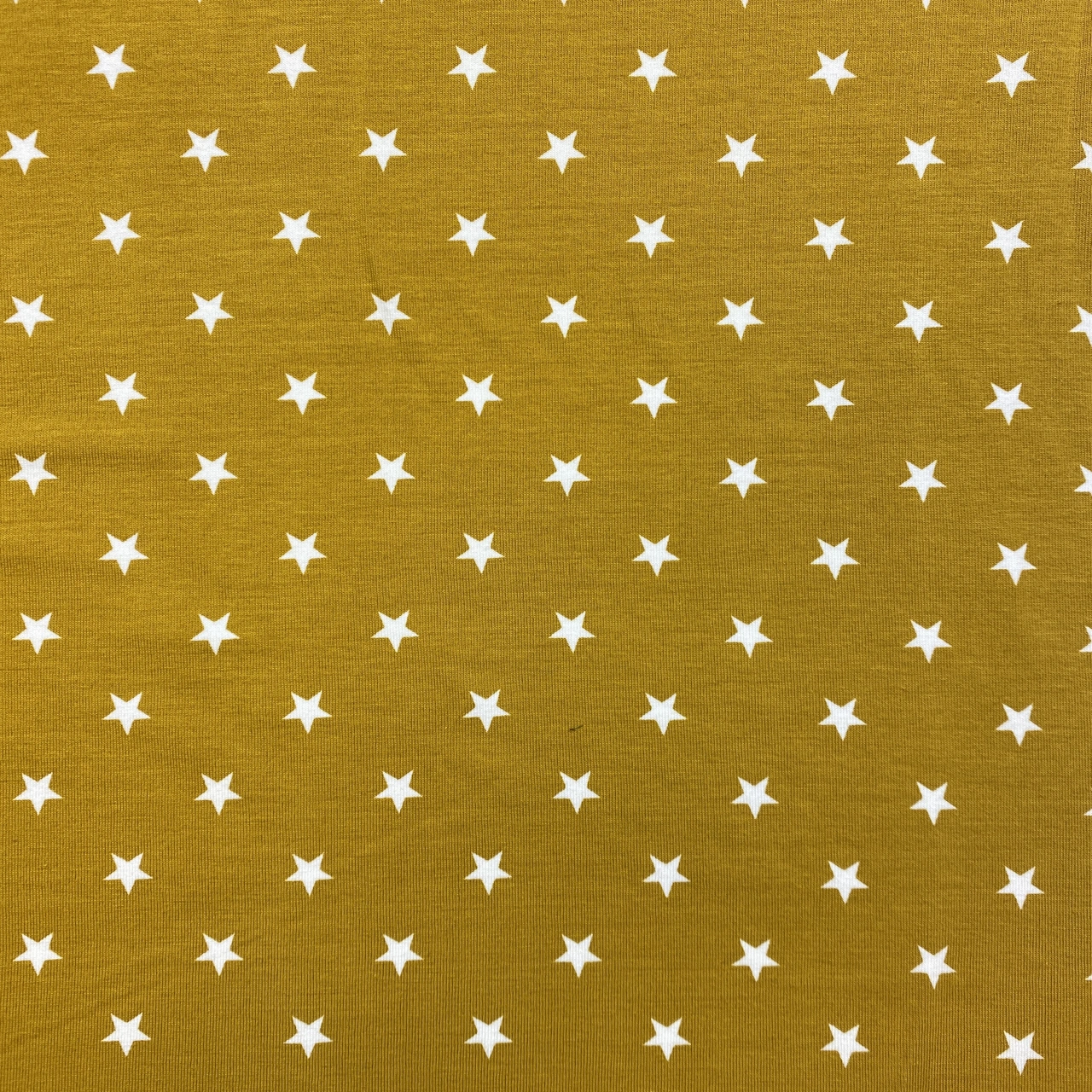 Stjärnor, ocra - Trikåtyg